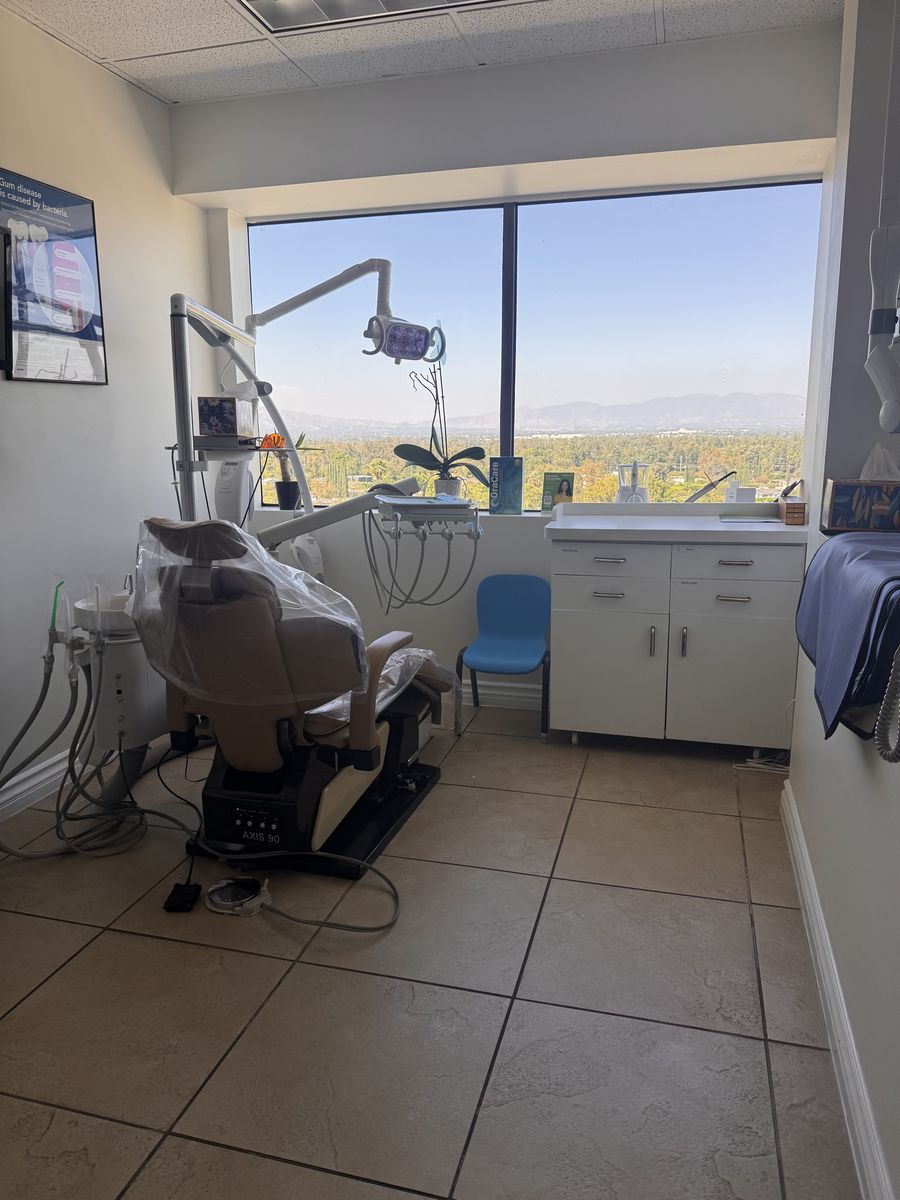 Treatment room with a dental chair and hillside view in Encino